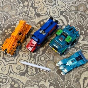 4 Transformers Vehicles: Blurr, Hoist, Optimus Prime & Grapple. Robots Disguise
